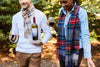 a guy and girl walking. the guy is wearing a cream and blue plaid cashmere scarf and the girl is wearing a blue and gray plaid cashmere scarf