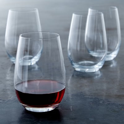 set of four (4) glass wine glasses. one has red wine in it
