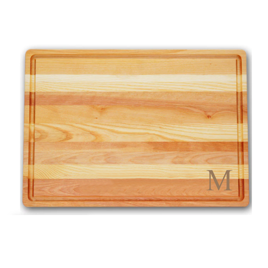 large cutting board made of yellow birchwood and new england ash monogrammed with M