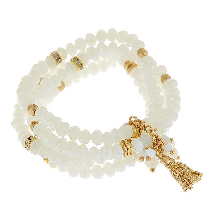 White beaded bracelet with gold tassle