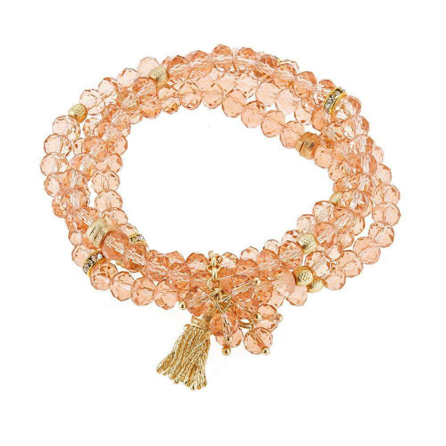 Pink beaded bracelet with gold tassle