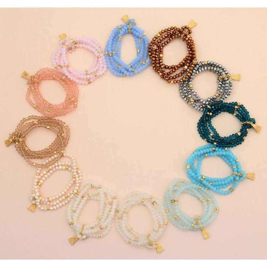 multi colored beaded bracelets with gold tassles